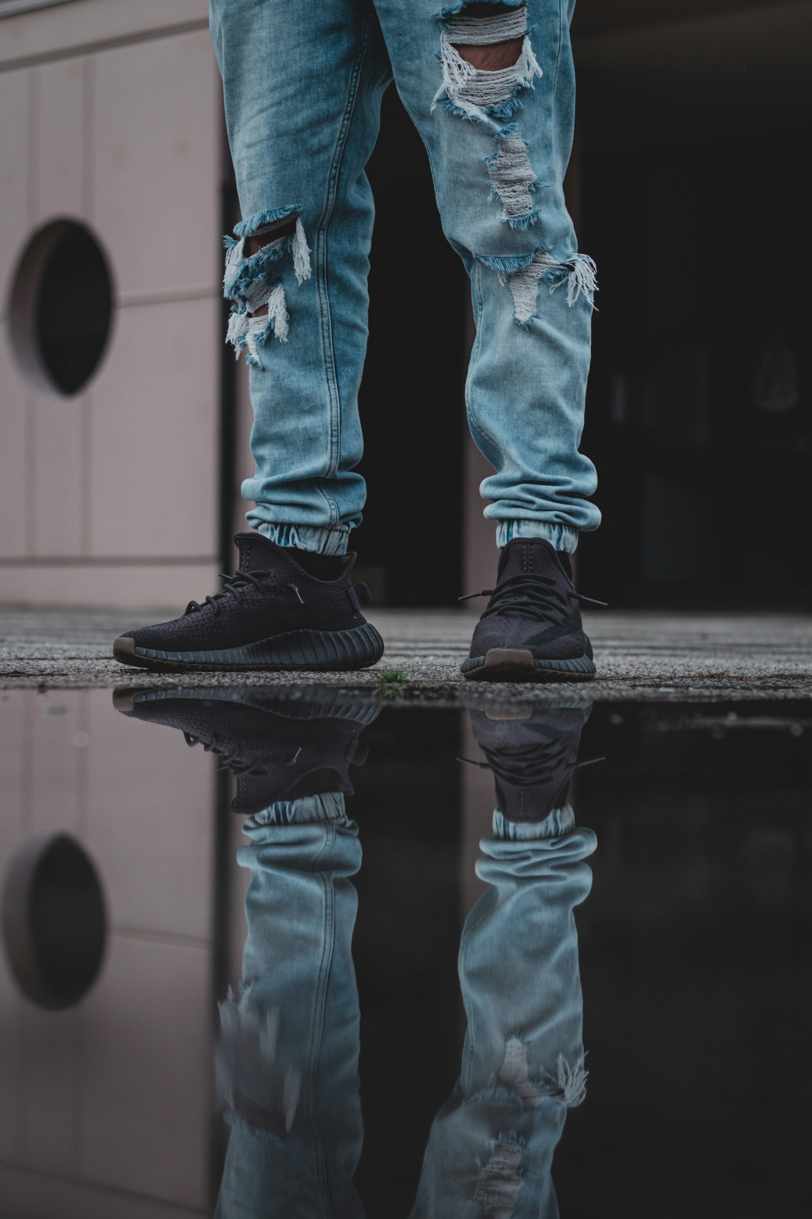 person in brown pants and white converse all star high top sneakers